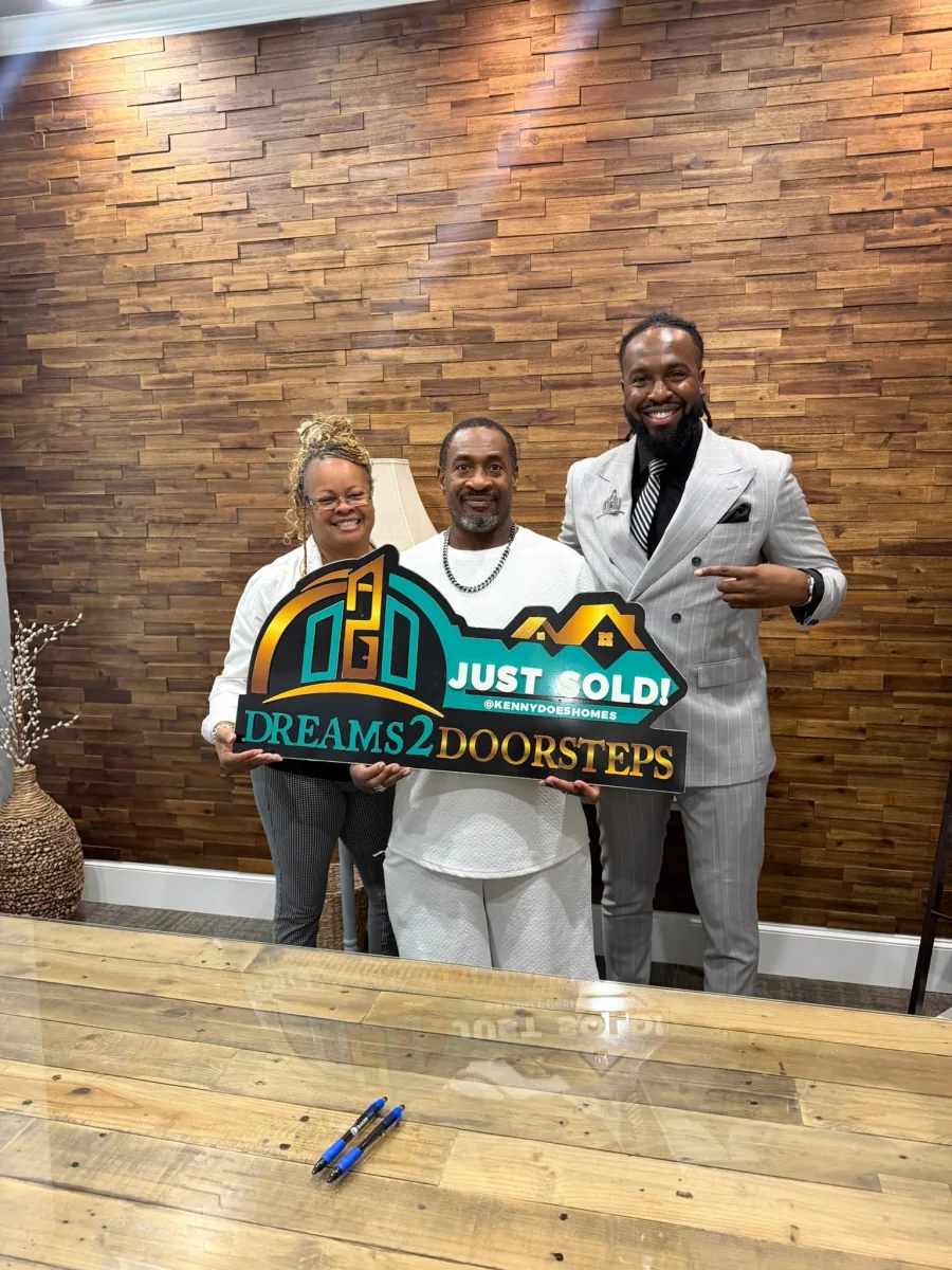 Three people celebrating a Dreams 2 Doorsteps closing day