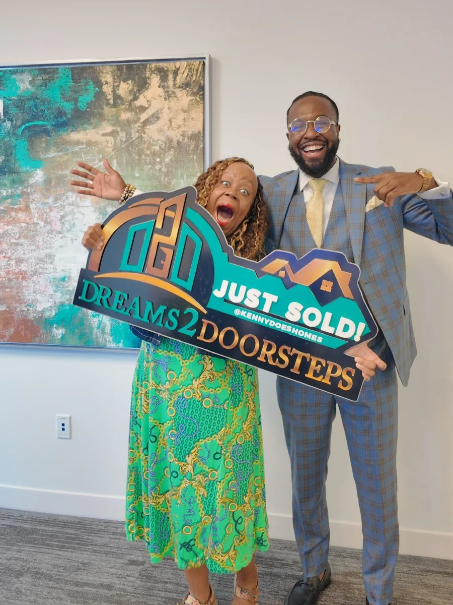 Dreams 2 Doorsteps clients celebrating on closing day with the Just Sold sign