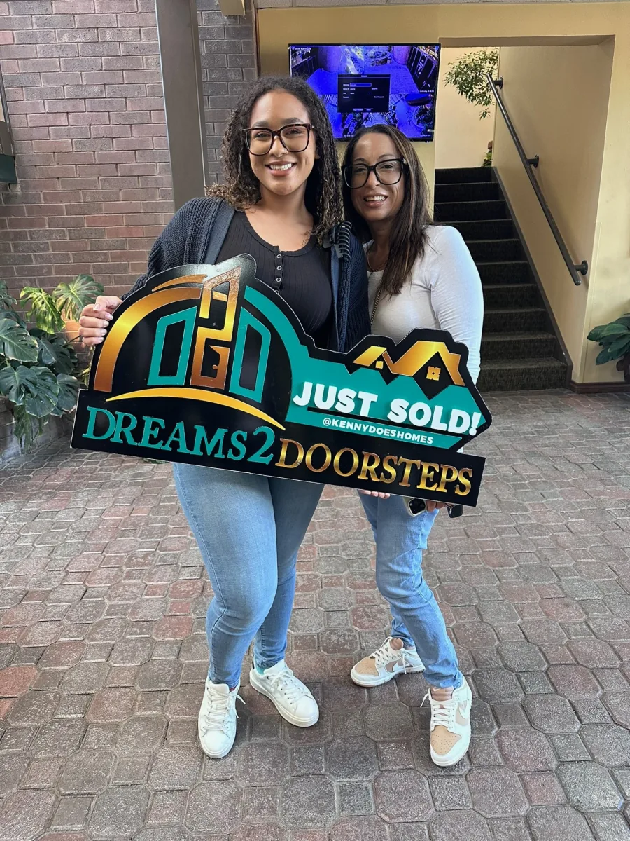 Two Dreams 2 Doorsteps clients celebrating together on closing day